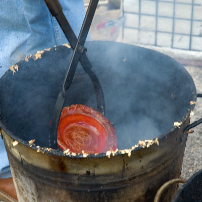 raku firing - heated ware being plunged into the reducing agent